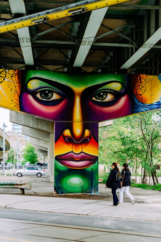 A colorful example of urban art painted on a support beam of an overpass. Used as an example.